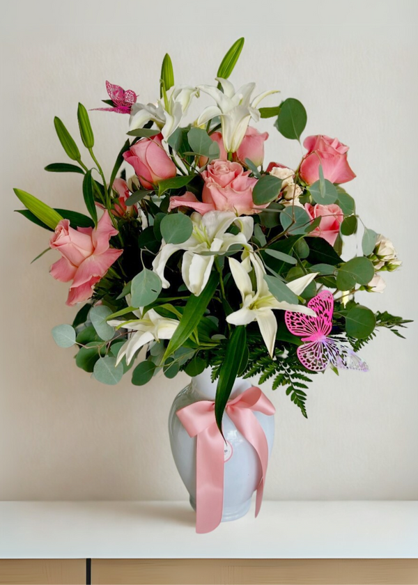 Arrangement of roses and mini-roses, lilies, and stock flowers, accompanied by assorted eucalyptus. Perfect for any occasion and Valentine's Day. Gladys Flowers Miami