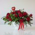 Striking arrangement of 24 roses and lush greenery.  Perfect for valentine's day.