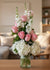 8 rose arrangement with hydrangeas and stock flowers in a vase